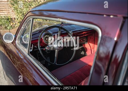 Detail of the interior of a beautiful classic American car, the Ford of the 49 bullet nose in purple Stock Photo