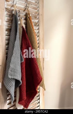 A closeup of kitchen towels hung on a wooden wall Stock Photo