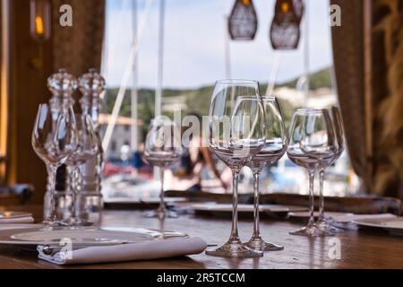 View of tables of an open air restaurant in Bonifacio touristic harbour Stock Photo