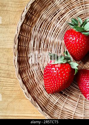 Fresh strawberries on wicker plate. Ripe berries close-up. Copy space. Selective focus. Stock Photo