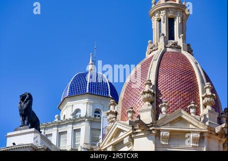 Valencia, Spain- July 15, 2022: Dome or cupola of the Generalli building (blue) and the city hall (red). Both are located in the town square. Stock Photo