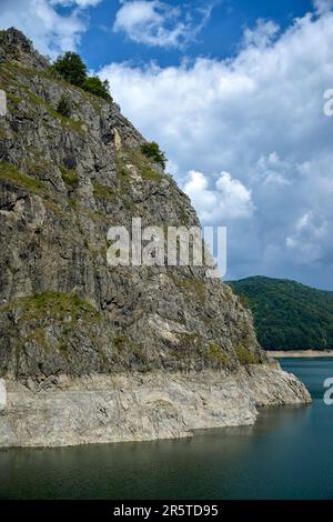 Scenic view of the reservoir of the Vidraru dam in Romania. A high rocky mountain on the artificially created Lake Vidraru. Copy space. Selective focu Stock Photo