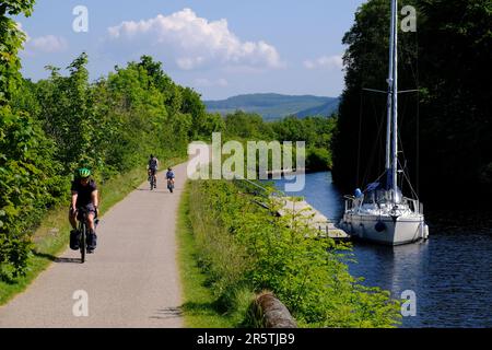Crinan, Scotland, UK. 5th June 2023.  Glorious warm and sunny weather continues on the west coast, people enjoying the outdoors in an attractive setting with the scenic villages along the coast.  Cycling along the Towpath on the Crinan canal.   Credit: Craig Brown/Alamy Live News Stock Photo