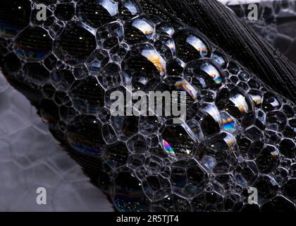 A grayscale of soap bubbles isolated on dark background Stock Photo
