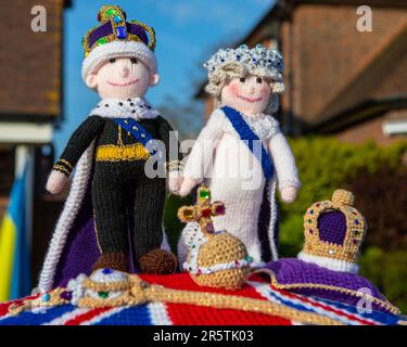 Sussex, UK - April 30th 2023: A knitted Post Box Topper on a red post box in the village of Cowfold in West Sussex, UK. Stock Photo