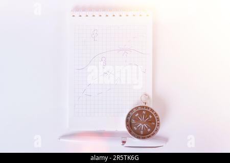 Traveler's notes. A clean notebook with a pen for writing a compass and a map . The concept of travel.. Stock Photo