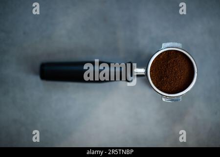 A close-up view of a portafilter with ground coffee for the coffee machine Stock Photo