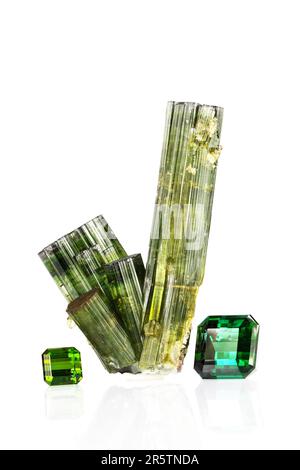 Green verdelite tourmaline crystal group specimen  with a 10ct  stone from a similar crystal and a 36ct faceted blue-green faceted gemstone, Namibia Stock Photo