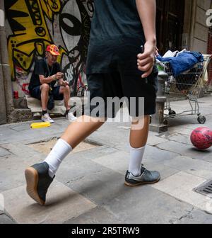 A drunk homeless beggar in the street of the city of Barcelona, Spain Stock Photo
