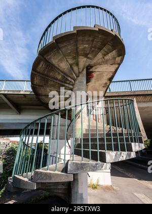 A concrete spiral staircase leads from the quayside of Bristol's Floating Harbour to the Plimsoll Swing Bridge. Stock Photo