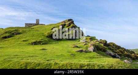 St Michael de Rupe Church stands on Brent Tor, a basaltic hill on the edge of Dartmoor in West Devon. Stock Photo