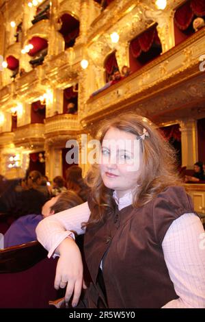 The picture was taken at the famous Opera House is located in Odessa, Ukraine. In the picture a nice girl waiting for the next action of the play. Stock Photo