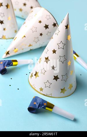Composition with party hats and whistles on pale blue background Stock ...