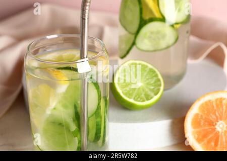 Glass and bottle of infused water with cucumber slices, closeup Stock Photo