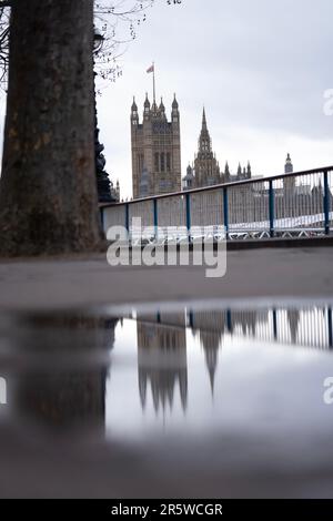 A scenic view of Westminster Abbey in London, England, reflecting in a puddl Stock Photo