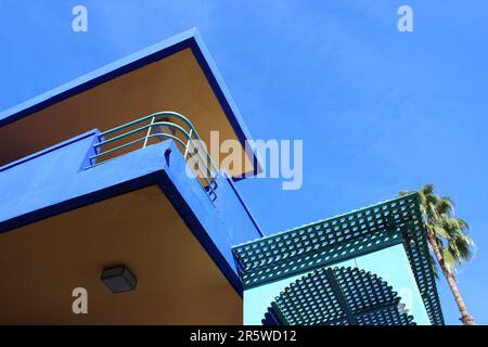 A low angle of a building with a balcony against a sunny blue sky Stock Photo