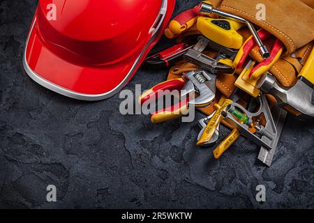 Linocut tools concept. Working tools in red and black colors on dark table  with copy space. Cutting instruments, ink roller and other tools for linocut  making. High quality photo Stock Photo 