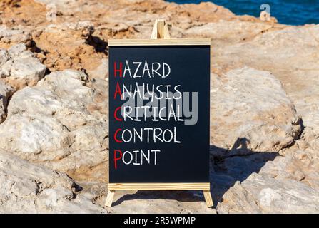 HACCP symbol. Concept words HACCP hazard analysis critical control point on black blackboard. Beautiful stone background. Business HACCP hazard analys Stock Photo