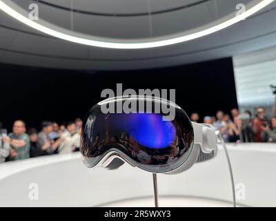 Cupertino, USA. 05th June, 2023. Media representatives and bloggers surround the Apple Vision Pro computer glasses on display in the Steve Jobs Theater on Apple's corporate campus in Cupertino. The novel headset had previously been presented by Group CEO Cook at Apple's WWDC developer conference. Credit: Christoph Dernbach/dpa/Alamy Live News Stock Photo