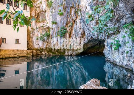 This striking image shows a beautiful artificial swimming pool nestled in the midst of a majestic mountain landscape Stock Photo
