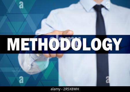 Man pointing at word Methodology on virtual screen, closeup Stock Photo