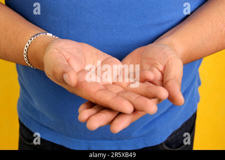 Hands of a Latino man makes sign language, expression and gesture-spatial configuration and visual perception with which deaf people Stock Photo