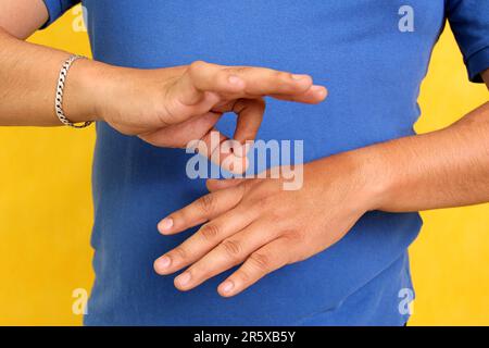 Hands of a Latino man makes sign language, expression and gesture-spatial configuration and visual perception with which deaf people Stock Photo