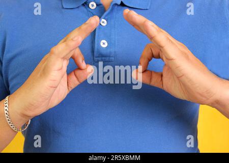 Hands of a Latino man makes sign language, expression and gesture-spatial configuration and visual perception with which deaf people Stock Photo