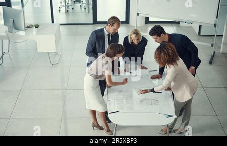Setting a solid foundation for structure. a team of corporate architects collaborating on a plan in a modern office. Stock Photo