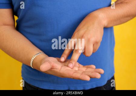 Hands of a Latino man makes sign language, expression and gesture-spatial configuration and visual perception with which deaf people Stock Photo