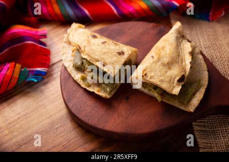 Quesadilla de Comal con queso y Nopales. Typical Mexican quesadilla made on a comal, very popular dish, one of the main street food in Mexico. Stock Photo