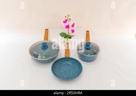 The Blue Pot and Fry Pan with Wooden Handle is a versatile and convenient cookware set that combines functionality with style. Stock Photo