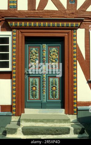 Beautifully decorated door on a half-timbered house Stock Photo