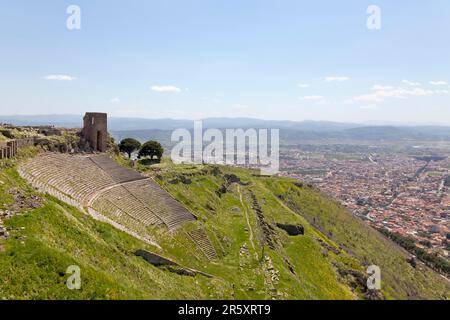The ancient theatre on the slope of the castle hill in Pergamon. Down in the valley, the present-day city of Bergama, Turkey Stock Photo