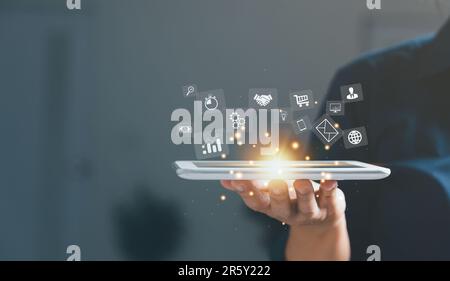Businesswoman hand working on tablet and smart phone with virtual icon. Business internet connection application technology and digital marketing, Fin Stock Photo