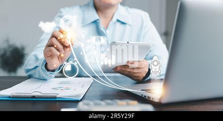 Startup concept with icon business and network connection on modern virtual interface from digital tablet. People hand touching on tablet.Developing a Stock Photo