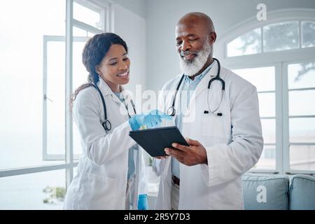 African doctors, teamwork and talk with tablet, data analysis or learning for healthcare in hospital. Senior black man, woman or medical mentor on Stock Photo