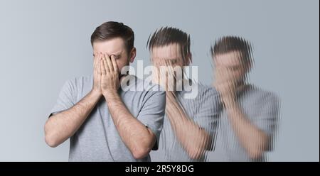 Scared man having hallucination on light grey background. Distorted image Stock Photo