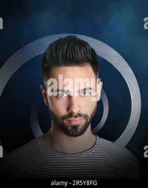 Suffering from hallucination. Young man in altered state of consciousness. Spiral behind him on dark background Stock Photo