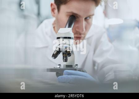 close up. the scientist looks through the microscope Stock Photo