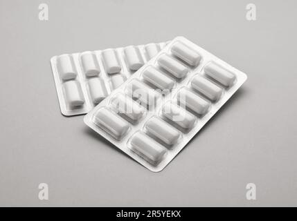 Blisters with chewing gums on grey background Stock Photo