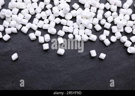 Delicious marshmallows on black background, flat lay Stock Photo