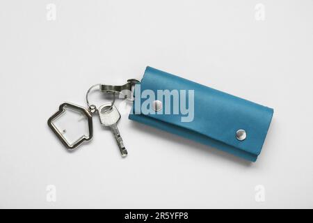 Leather case with key on light grey background, top view Stock Photo