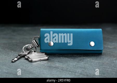 Leather case with key on grey table, closeup Stock Photo