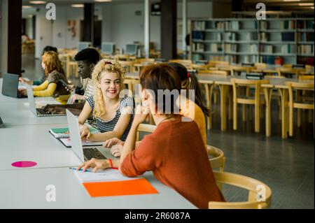 Group of multiethnic students sitting in library Stock Photo