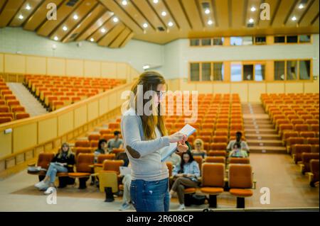 Serious woman standing with notebook in conference room Stock Photo