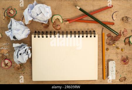 Stationary, notebook with color pencil and on table with paper. Mock up space or planning, abstract or top view and sketchpad or drawing book for Stock Photo