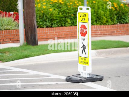 State Law Pedestrian Crosswalk Sign on a well traveled street in a neighborhood Stock Photo