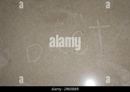 Dust written on dusty floor Stock Photo