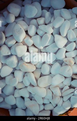 The white pebbles on a dark surface Stock Photo